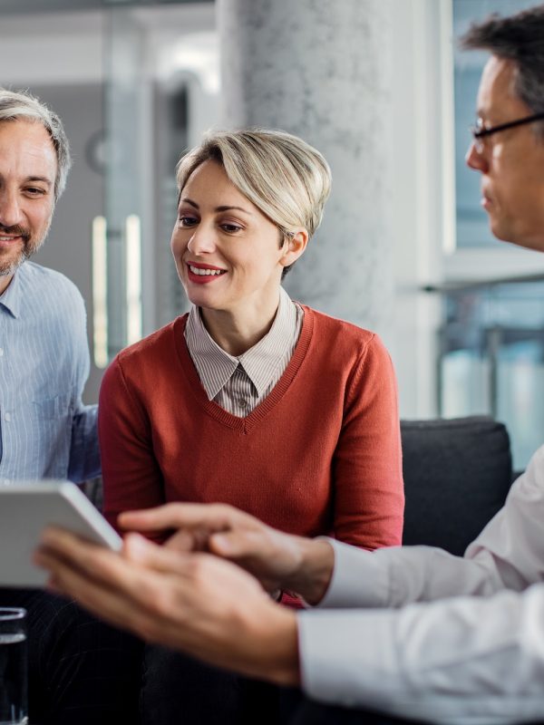 happy-mid-adult-couple-using-touchpad-with-their-financial-consultant-in-the-office-.jpg happy-mid-adult-couple-using-touchpad-with-their-financial-consultant-in-the-office-.jpg